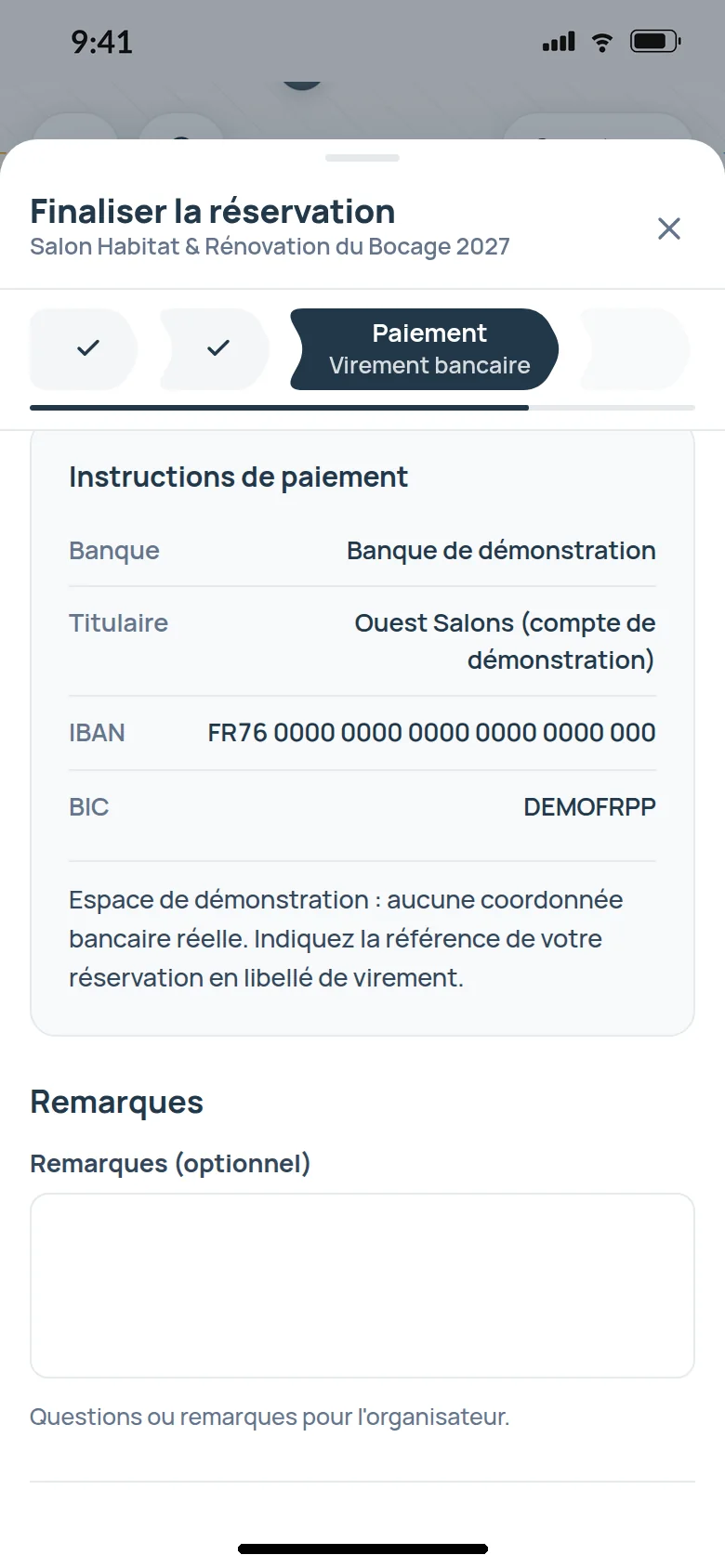 The Payment step of the booking journey on the exhibitor site of a demo trade show, in French, on a phone, bank transfer chosen, with the organizer’s payment instructions, the bank, the account holder, a demo IBAN and BIC, and the instruction to quote the booking reference as the transfer label.